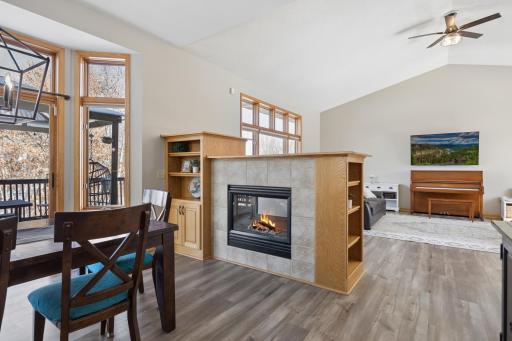 A close up of the transition from living to dining space and the fireplace with additional built-in shelving.