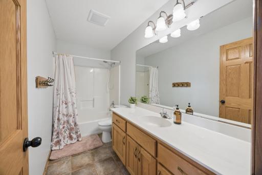 The main floor bathroom with plenty of counter space and large mirror.