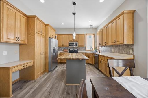 Another view of the kitchen from the dining area. Note the recessed lighting and pendant lighting over the counter top.