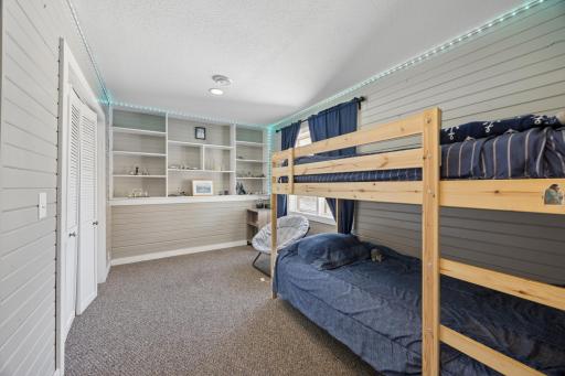 Lower-level bedroom. This space features a large closet and is a perfect 5th bedroom or guest bedroom.