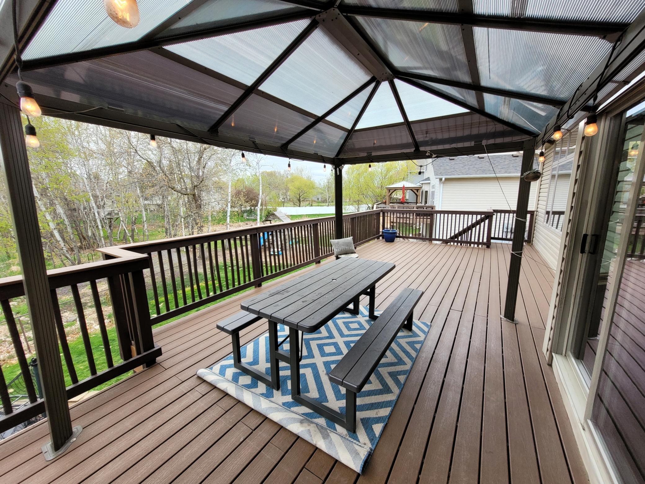 The large back is maintenance free and offers a great place to entertain overlooking the backyard and nature! The pergola will stay with the home. Stairs down to the backyard are on the far end for easy access!