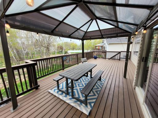 The large back is maintenance free and offers a great place to entertain overlooking the backyard and nature! The pergola will stay with the home. Stairs down to the backyard are on the far end for easy access!