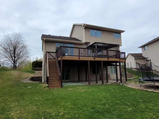 The backyard offers lots of space to enjoy having fun. Also, the lot extends further back to a fire pit and woods! The deck steps are great to access the backyard!