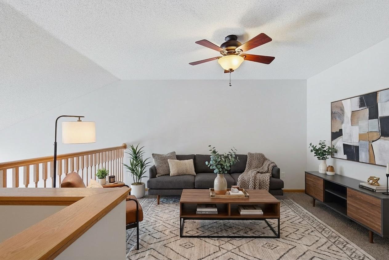 Upper level loft open to main level has ceiling fan with lights. Virtually staged.