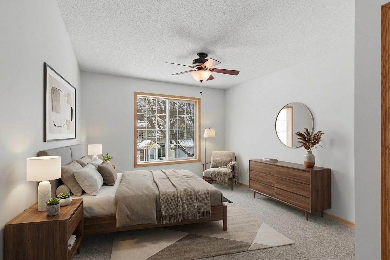Owner's suite on upper level with ceiling fan and light, virtually staged.