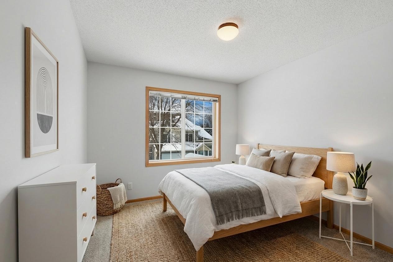 Second bedroom on upper level with overhead light, virtually staged.