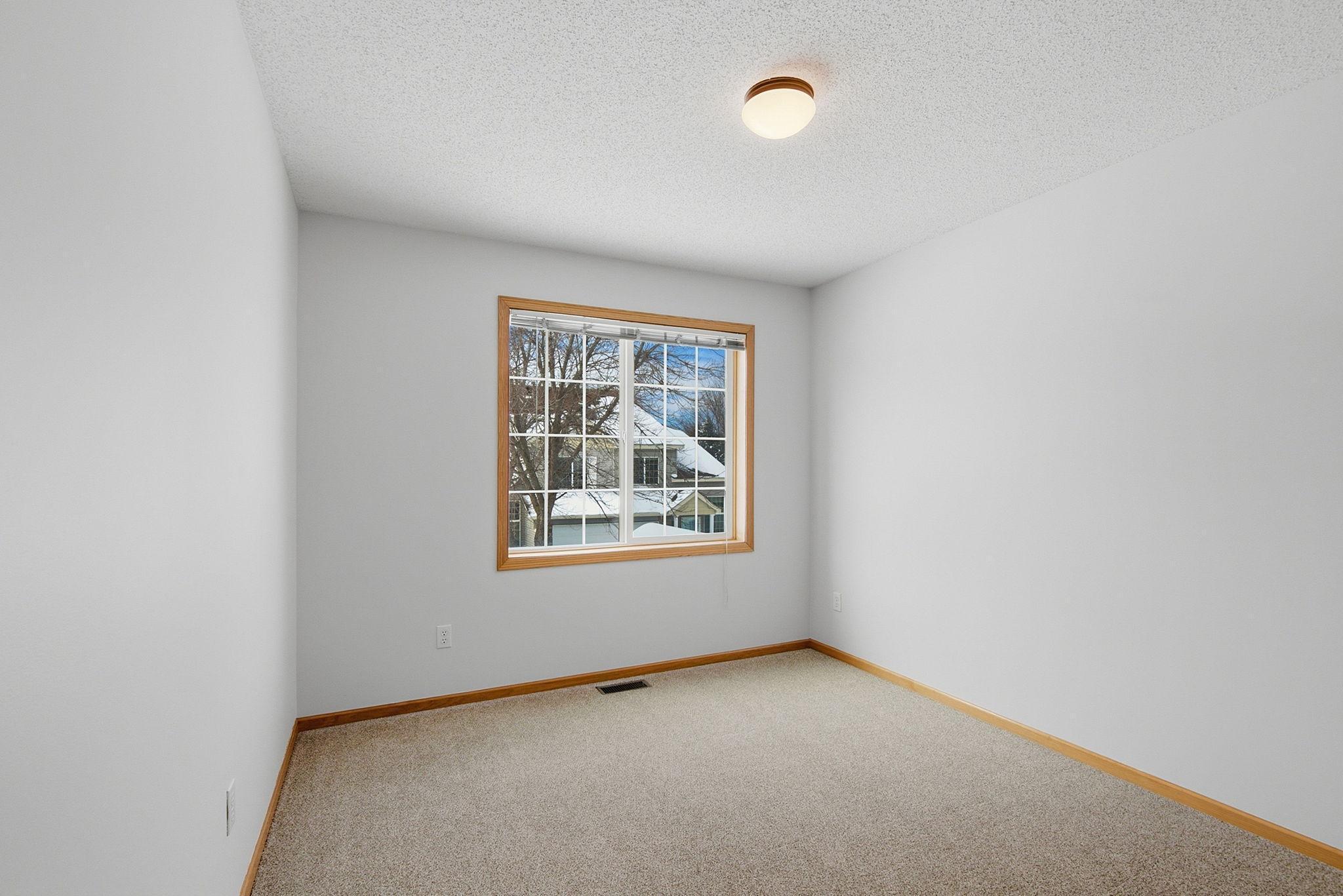 Second bedroom on upper level with overhead light.