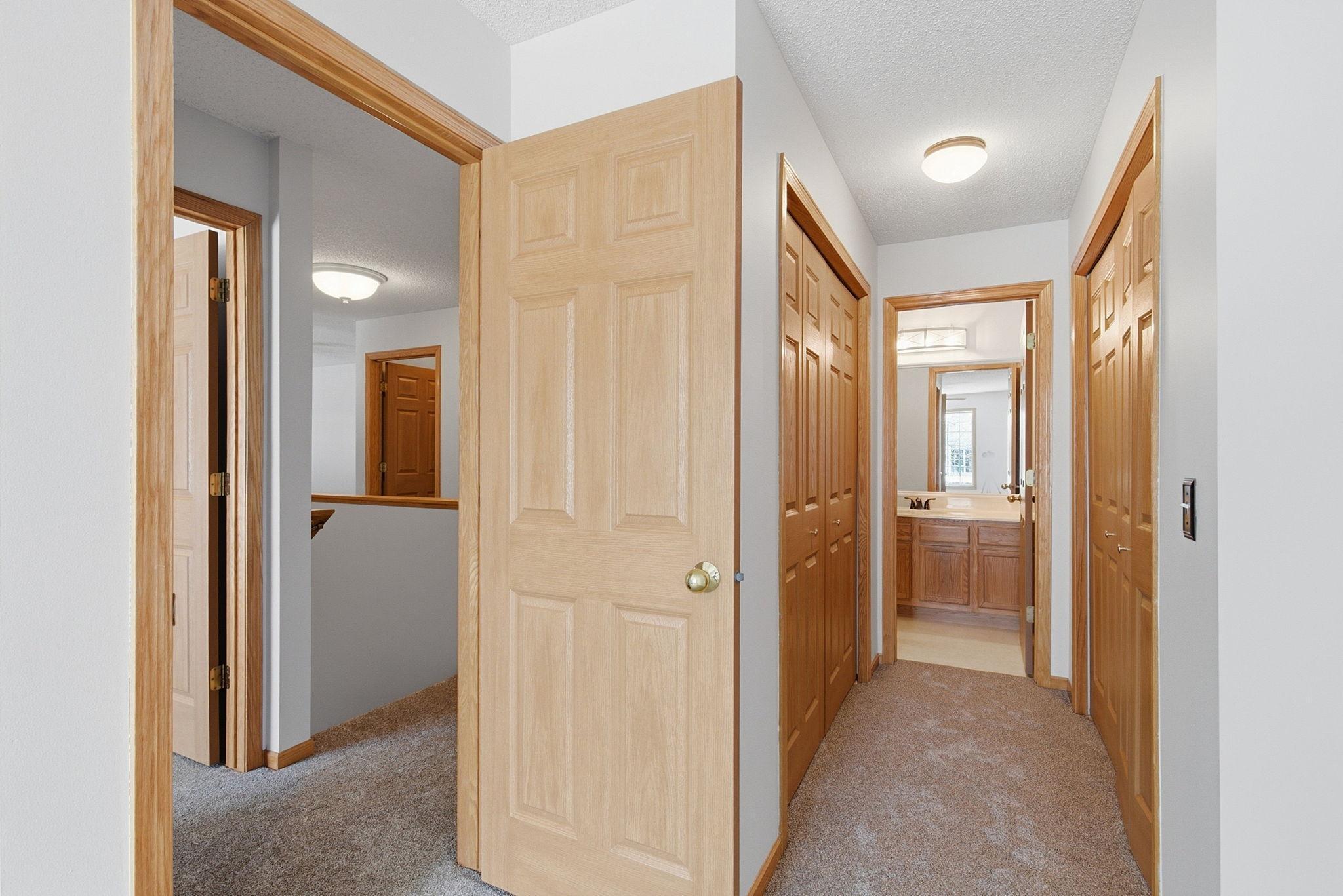 Double-closets in owner's suite, view to walk-through full bath