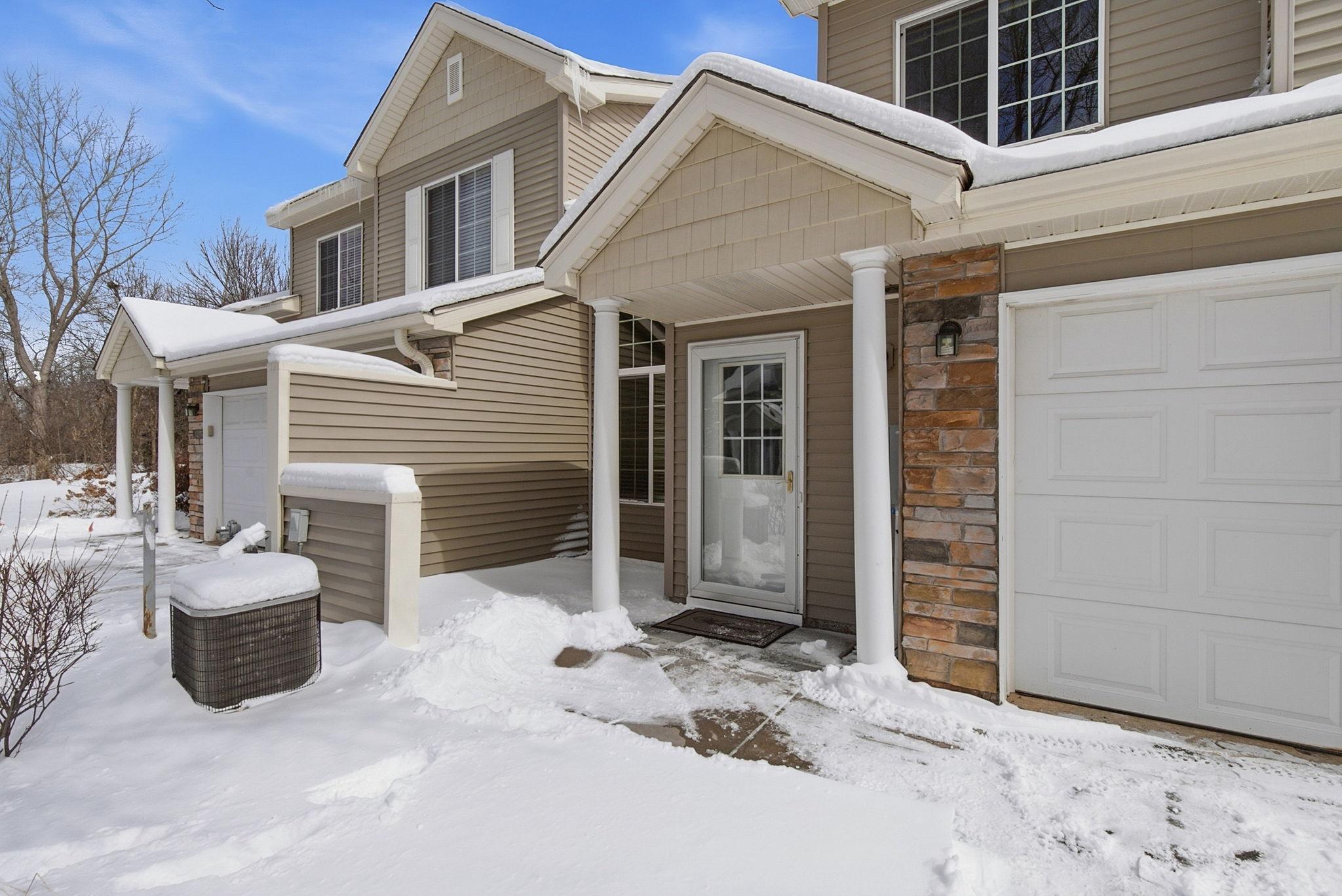 Attractive vinyl siding with stone accents, covered entry, patio with privacy wall.
