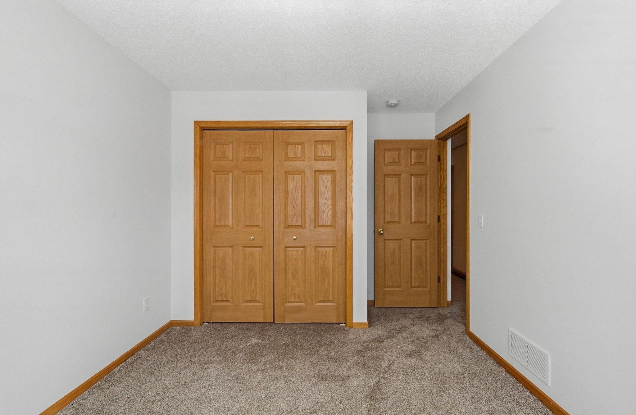 Nice sized closet in second bedroom with raised panel doors.