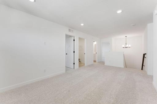 (Photo of an inventory home, actual homes finishes will vary) Well-lit upper level loft doubles as a second family room.