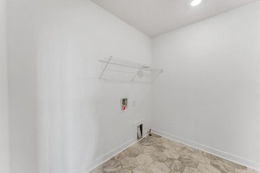 (Photo of an inventory home, actual homes finishes will vary) The upper level laundry room is set up for a gas dryer.