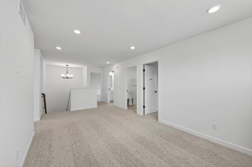 (Photo of a similar home, features will vary) Well-lit upper level loft doubles as a second family room.