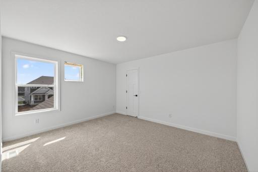 (Photo of a similar home, features will vary) One of three generously sized secondary bedrooms with spacious closets.