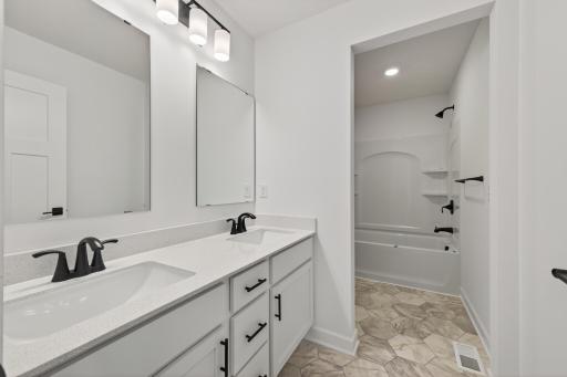 (Photo of a similar home, features will vary) Featuring a double vanity, this secondary bath is sure to keep everyone moving during those busy mornings!