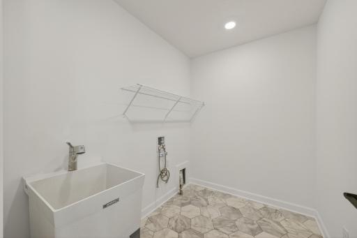 (Photo of a similar home, features will vary) Upper level laundry room is set up for a gas dryer.