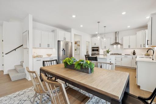 (Photo of a similar home, features will vary) Always bright and light filled, this home will feature a sliding glass door next to the dinner table!