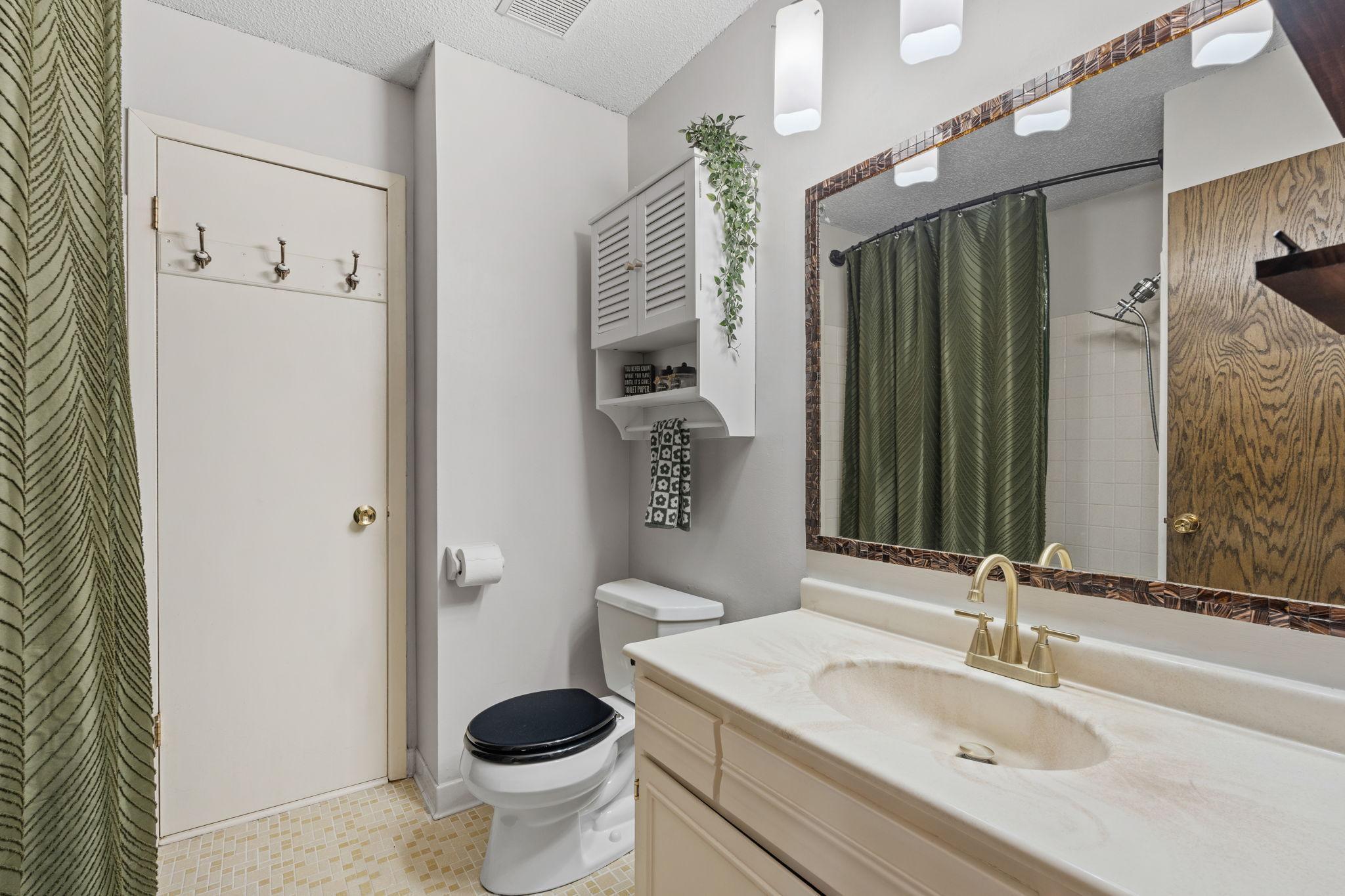 Main level bathroom with LOTS of storage in the closet