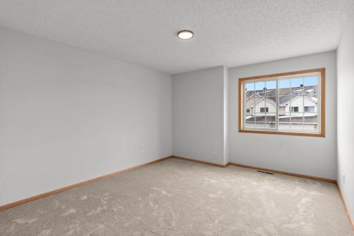 Primary Bedroom is Spacious and offers New Carpeting, New Lighting and Freshly Painted Walls.