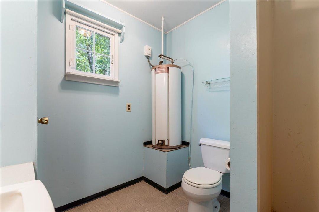 3/4 bathroom in the main cabin also houses the hot water heater.