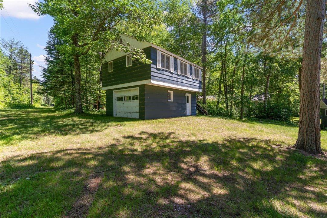 This is the first building you'll see on the property. Main level is a 1 car garage with a semi-finished space above complete with a half bathroom, kitchen and plenty of space for a living room or sleeping arrangements.
