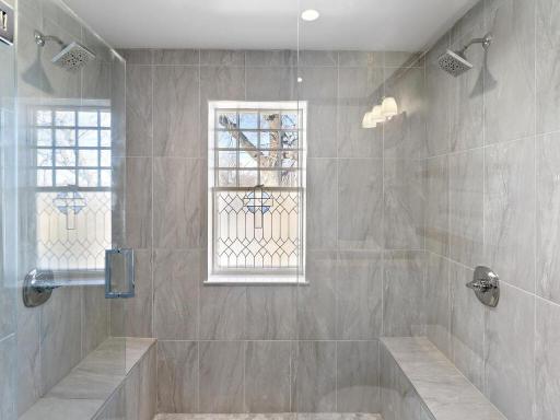 Beautifully renovated upper-level shower with sleek tile surround and contemporary fixtures.