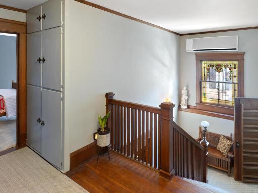Historic main staircase featuring an original secondary stairway to the kitchen (open door to the right side of picture), traditionally used by staff for seamless service and separation of formal spaces.