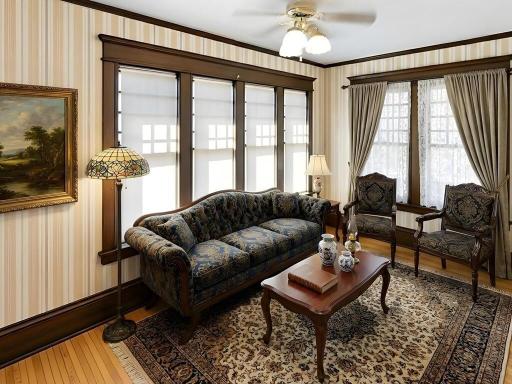 Upper-level sunroom virtually staged to illustrate its potential as a charming sitting room.