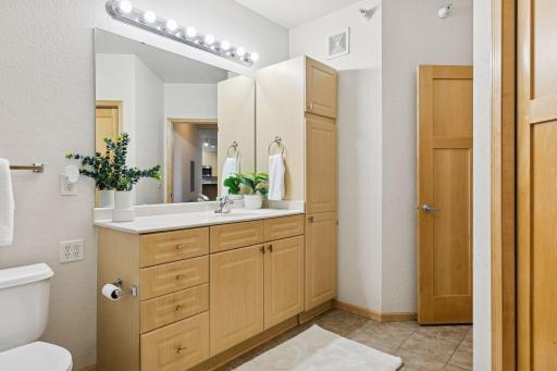 Large bathroom with extra storage, tile floors, and a separate tub and shower.