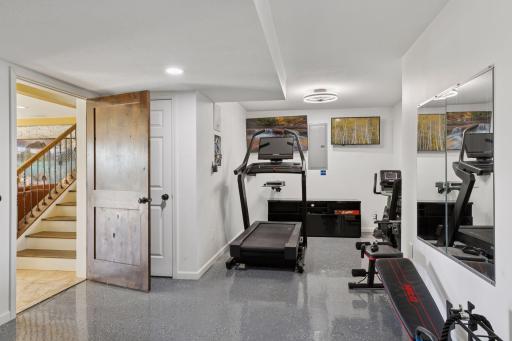 For fitness enthusiasts, a large 21' x 14' exercise room is equipped with two mounted TVs.