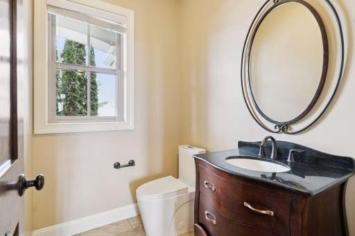 Main Floor 1/2 bath located in back hall area near the garage entrance.