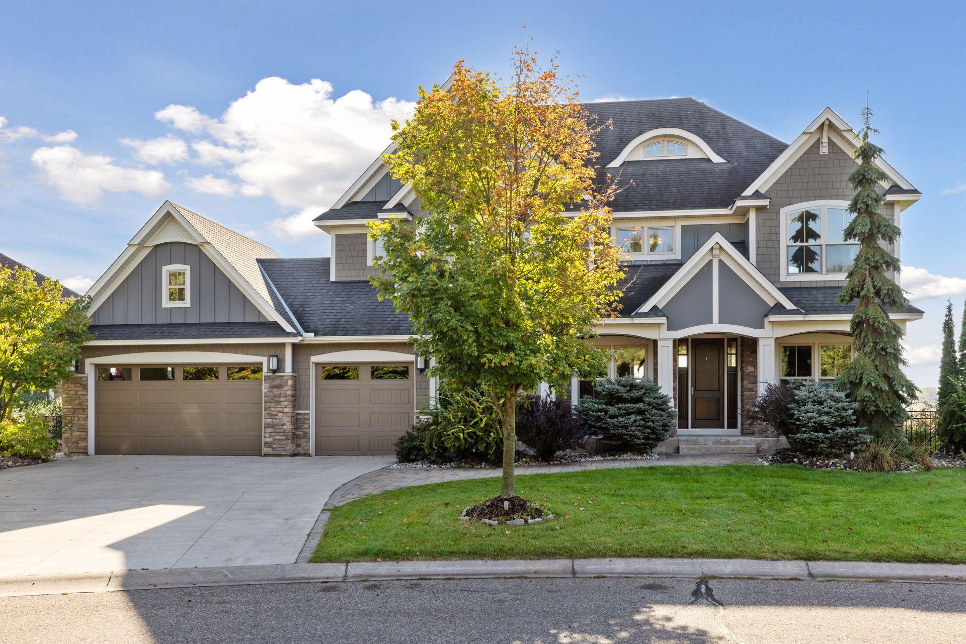 The home’s curb appeal is equally striking, with four sides of durable Hardieboard siding accented by stone, a wide concrete driveway, and a charming brick paver walkway leading to the front porch.