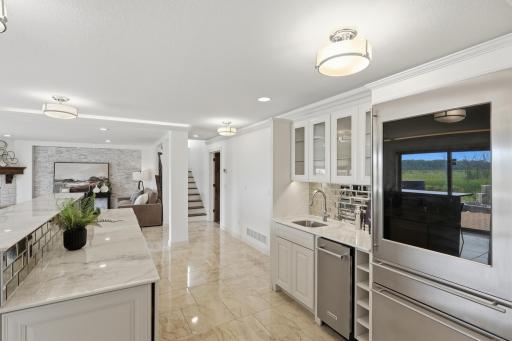 Complete with a few beverage and wine coolers, an ice maker, refrigerator, sink, and ambient lighting, it’s an entertainer’s dream.
