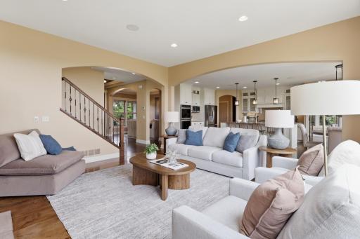 The main level features warm hardwood floors, 8-foot knotty alder doors, vaulted ceilings, and detailed trim that showcase the quality of construction throughout.