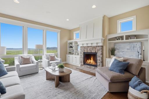 The family room is a showstopper with its wall of windows framing the nature preserve beyond, complete with a gas fireplace and custom built-ins.