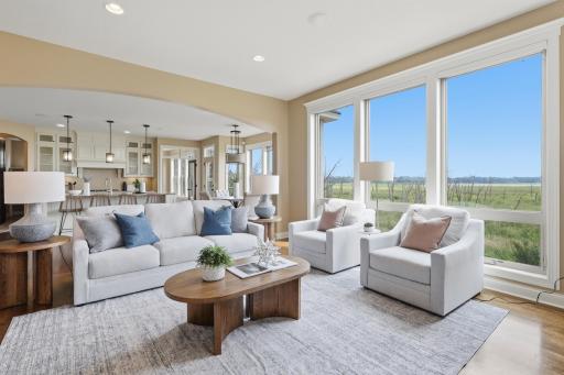 Floor to ceiling windows allow for a sun-filled living room.