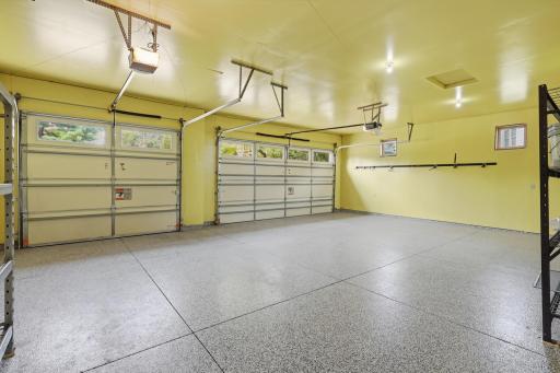 Epoxy flooring, insulated and painted walls/ceiling, water faucet bib on wall, garage door openers.