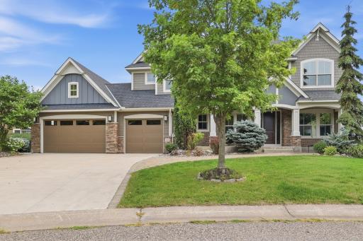 The home’s curb appeal is equally striking, with four sides of durable Hardieboard siding accented by stone, a wide concrete driveway, and a charming brick paver walkway leading to the front porch.
