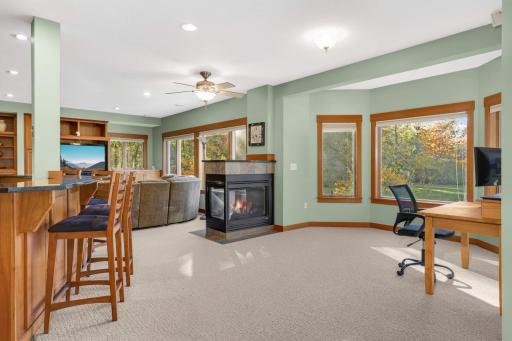 bar area and fireplace in lower level