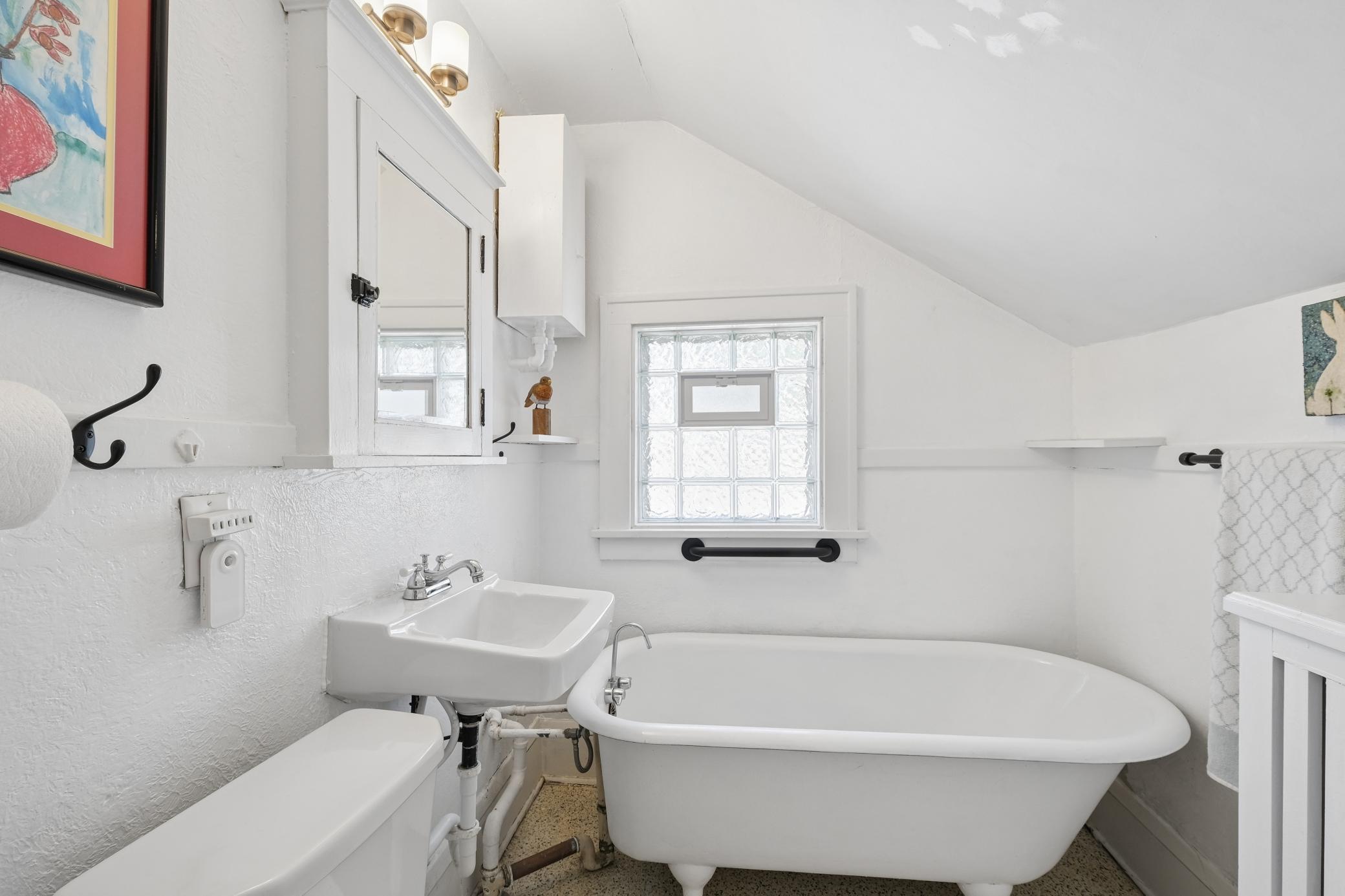 Upper level bathroom with original claw foot tub. A FAVORITE feature of the current owner