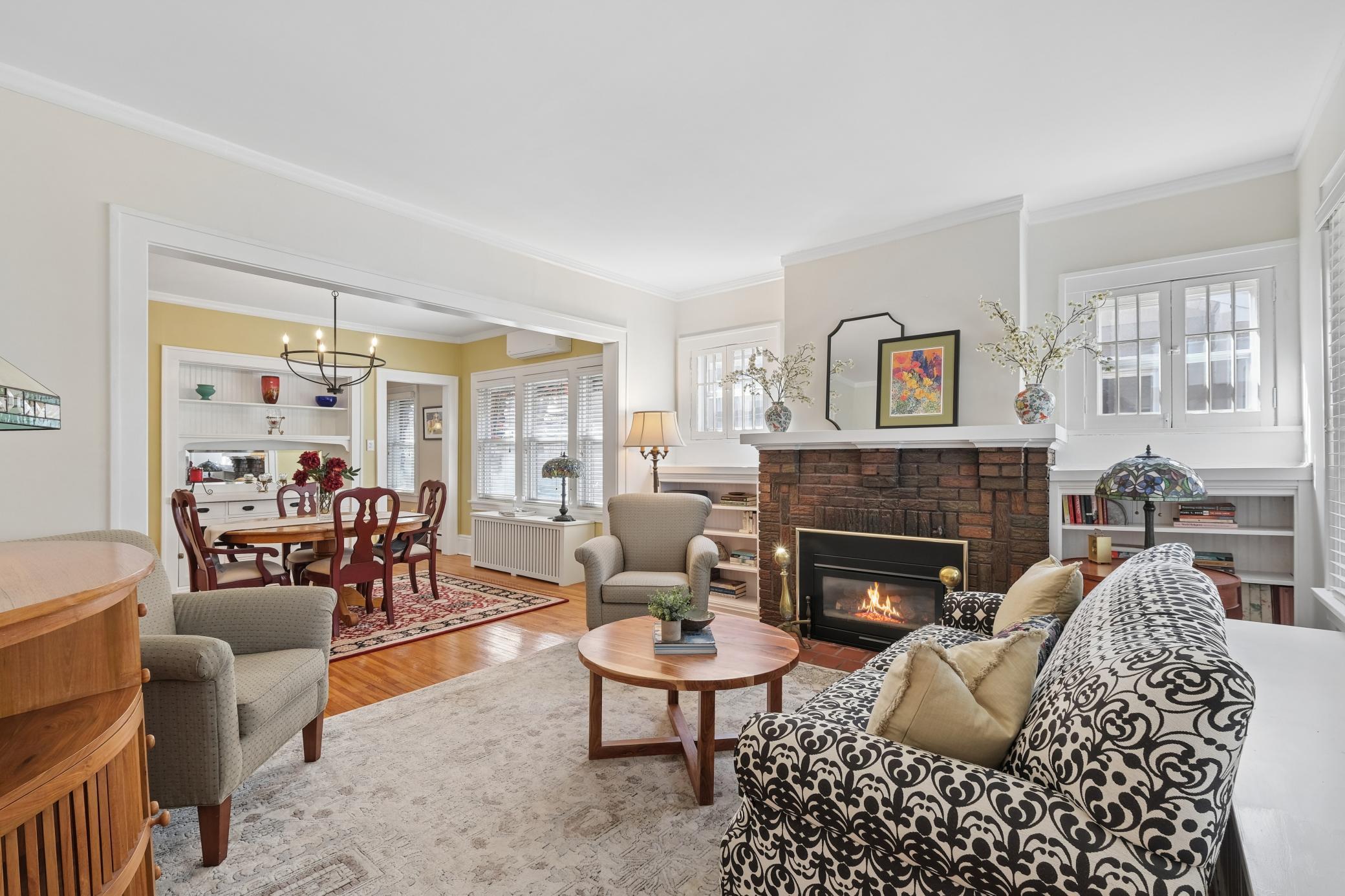 Beautifully welcoming living room with hard wood floors, gas fireplace