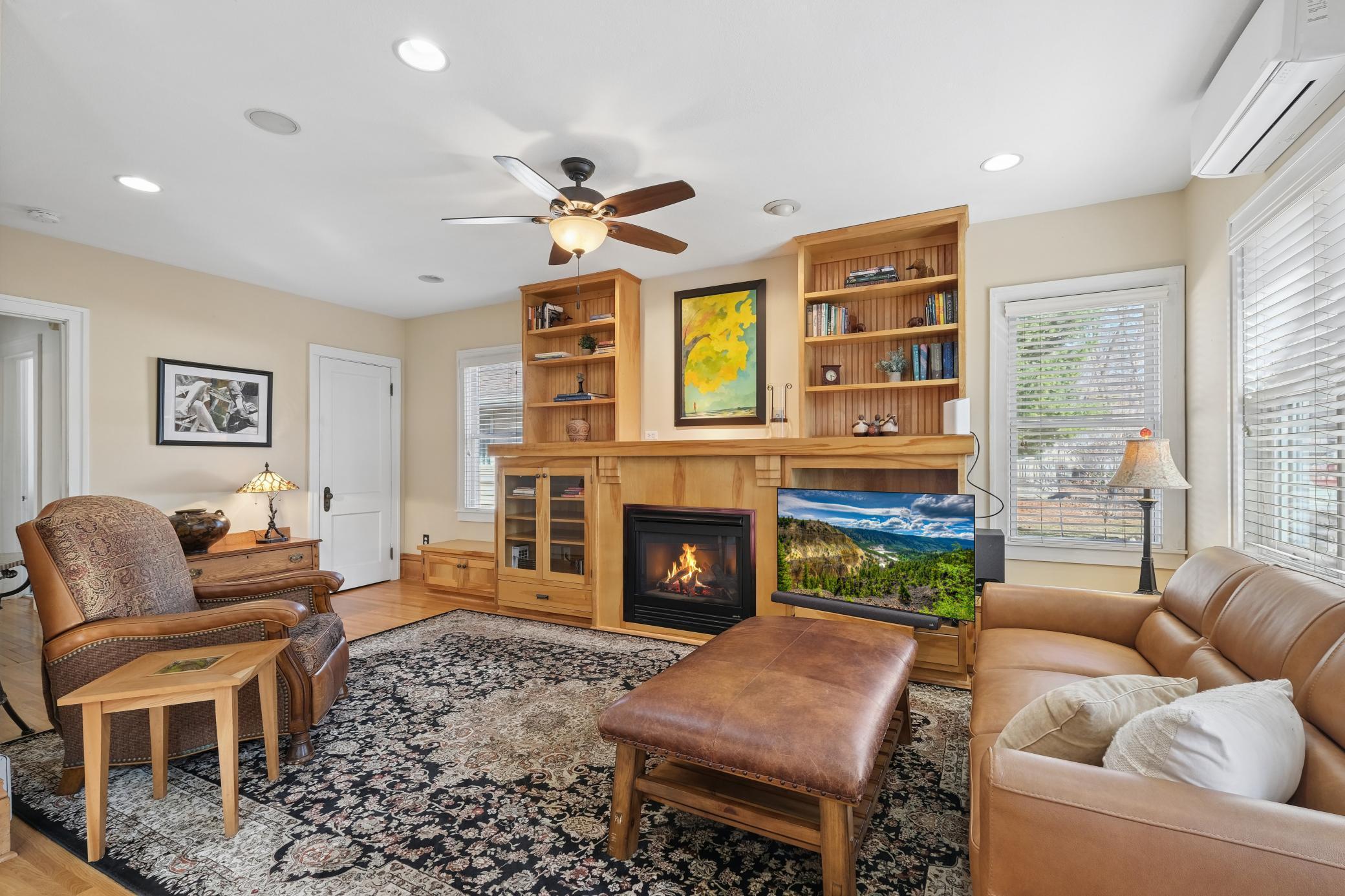Adjoining the kitchen is this beautiful family room with gas fireplace and display shelves flanking the fireplace.