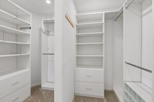 Primary bedroom walk-in closet with custom organizers.
