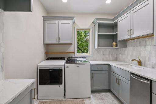 Remodeled laundry, with custom cabinets, backsplash, and pebble ice maker.