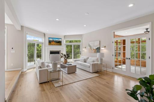 Spacious sunken family room with French doors leading to the cozy sunroom.