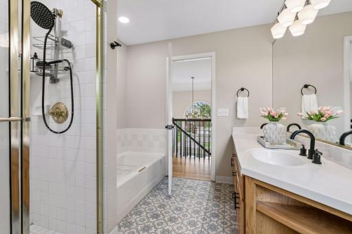 Full tub and separate step-in shower, with double-sink vanity.