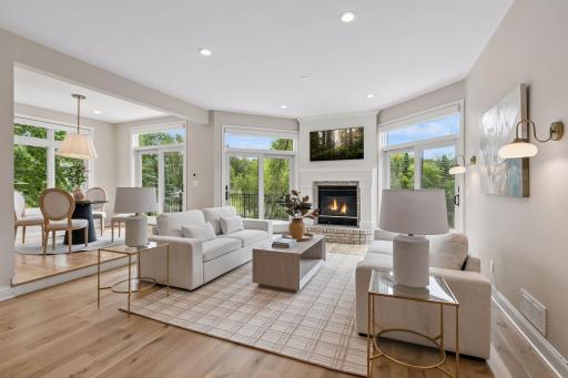 Beautiful hardwood floors, wall sconces, and gas fireplace create an inviting atmosphere.