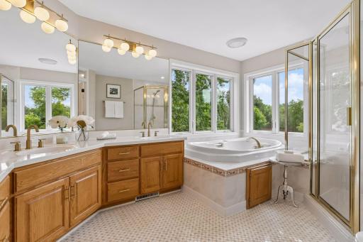 Private primary ensuite bath with jetted tub and double vanity.
