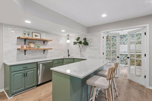 Wet bar includes a full-size bosch dishwasher and counter seating.