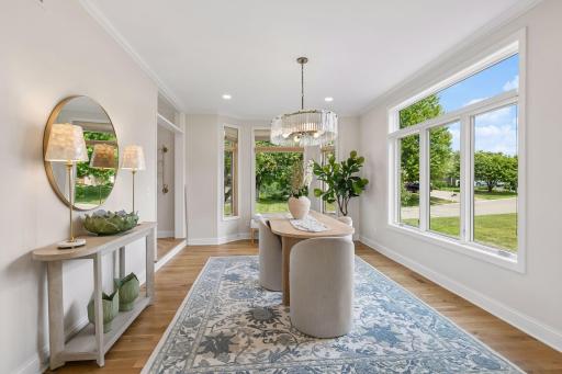Formal dining room with glamorous chandelier oversized windows.